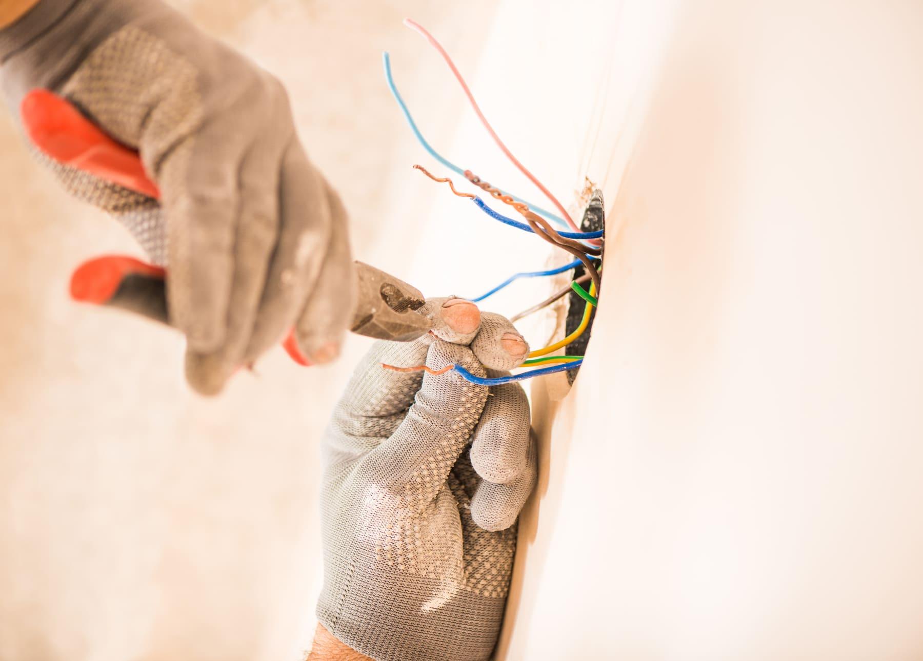 Electrician wiring an outlet